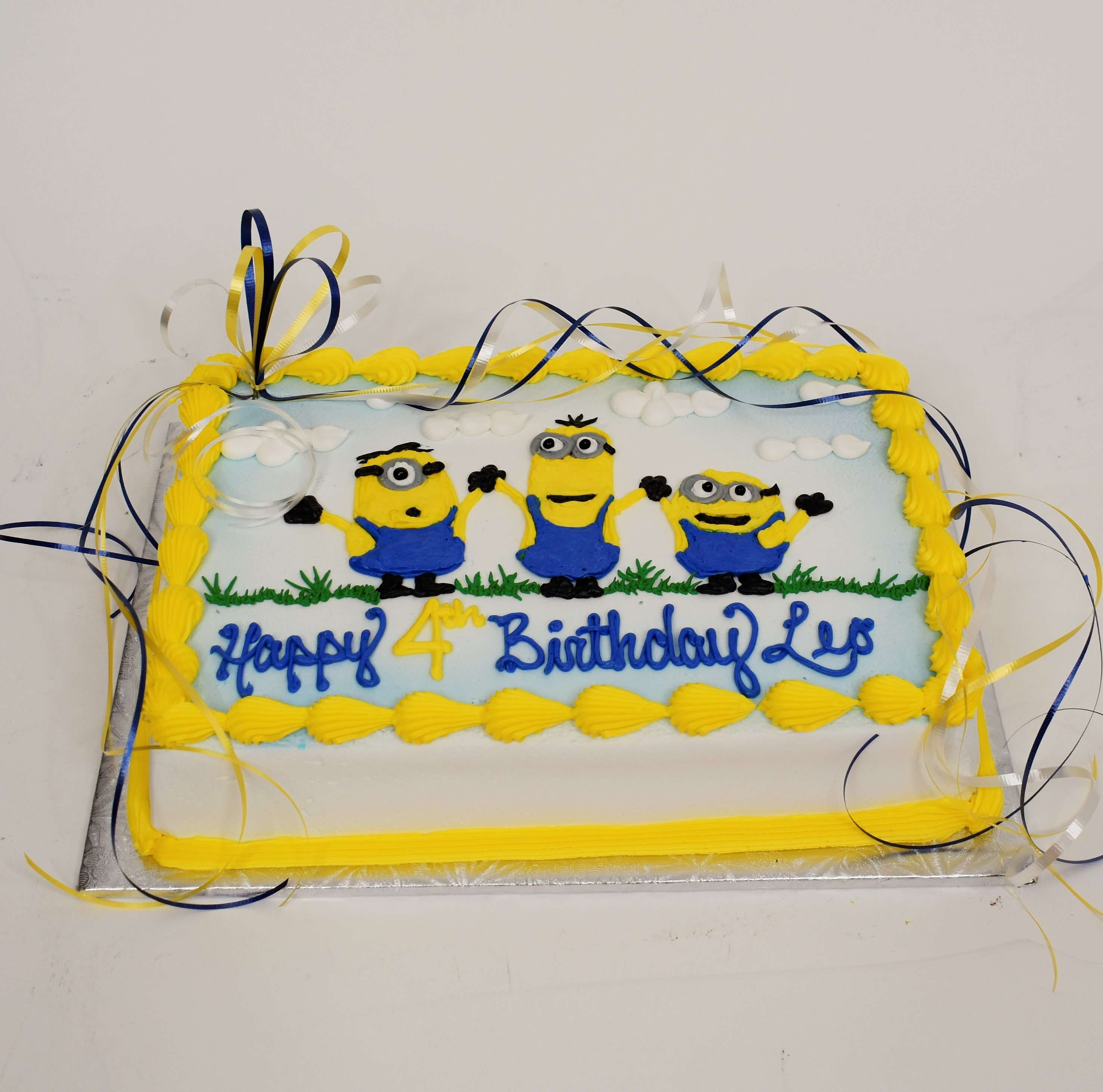 Three Minions Celebrating Cake
